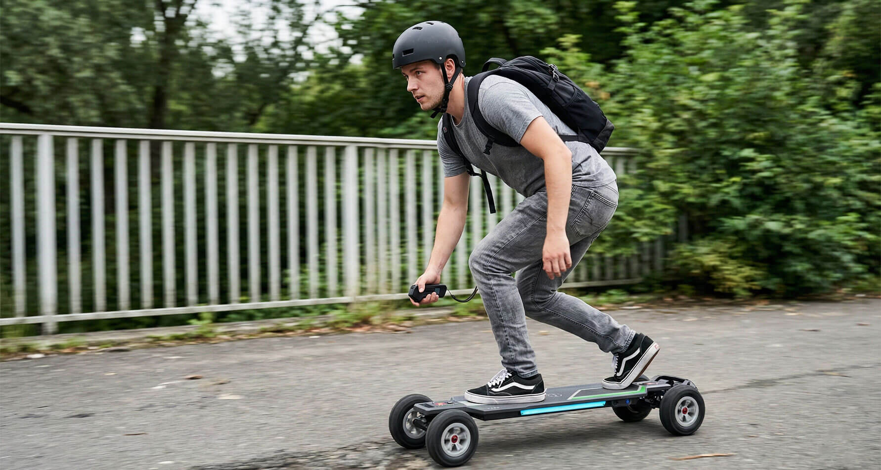 Rider commuting on an all-terrain electric skateboard.